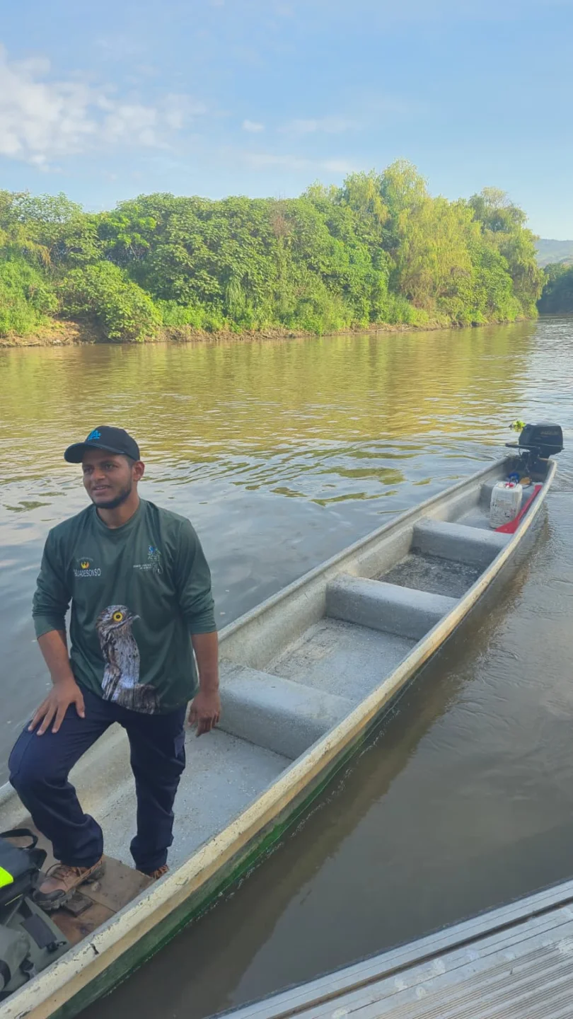 Guía local junto a la lancha utilizada para el avistamiento de aves en el río Cauca Guía local junto a la lancha utilizada para el avistamiento de aves en el río Cauca